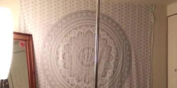 Pole dancing topless at home