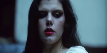 Offering herself to strangers in a garage (vintage flick)