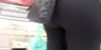 Woman in black leggings at the supermarket