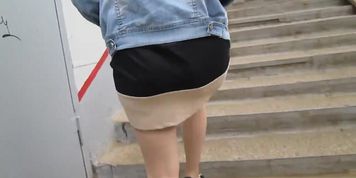 Girl in tan stockings going upstairs