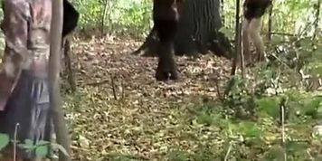 Shy woman in skirt and black boots peeing