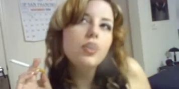 Beautiful busty redhead smoking & dangling