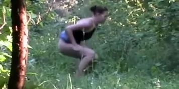 Woman in jeans skirt piss in the nature