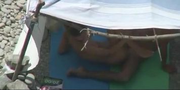 Nudist couple caught fucking under tent