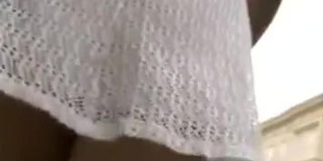 Girl in white knitted dress teasing with erotic upskirt