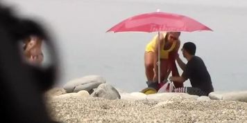 Chubby girl undresses at the beach