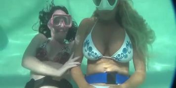 Woman holding breath underwater in Cressi mask