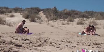 sunbathing on a nude beach, guy joins her and other couple gets horny too