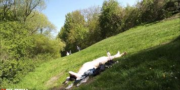A man sunbathes completely naked in a park in  ...
