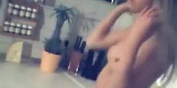 Striptease in the kitchen from a sexy blonde