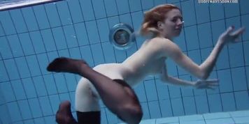 Hot teen with black leather clothes underwater
