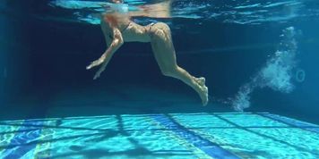 Very fit girl Mary Kalisy swims freely nude