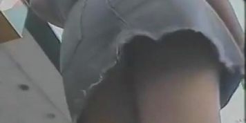 Summer girl with pony tails and jeans skirt voyeur video