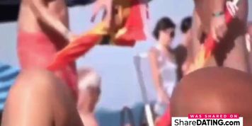 a couple masturbates on nudist beach