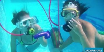 Two hot lesbians playing with dildos in the pool