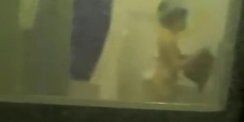 Girl shows her round titties to the window voyeurer