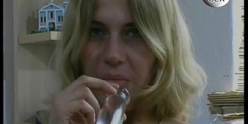 Young blonde has a transparent dildo