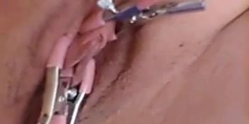 Pussy clinching  on benwa balls with clamps on