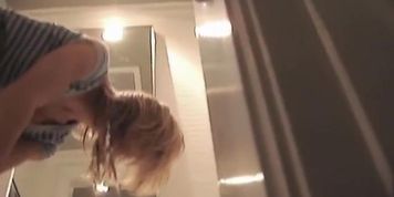 Blonde in fitting room puts on panty and tight jeans