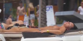 Voyeur video of topless babes on the beach