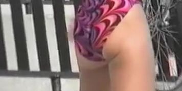 Candid girl in colorful bikini bends over showing the ass 06ze