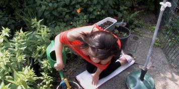 Tibby exposes boobs while gardening