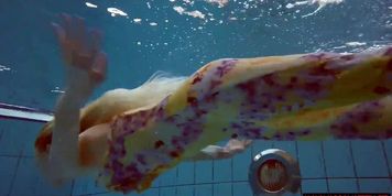 Blonde in a dress in a pool