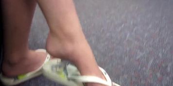 Candid library dangle white flip-flops. Blue toenails