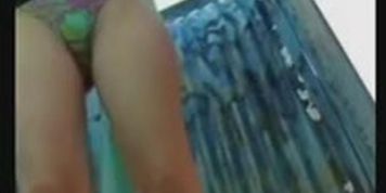Woman is taking her clothes off in a fitting room