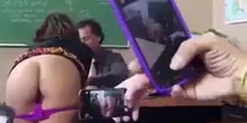 Student Flashing in Classroom Talking to Teacher