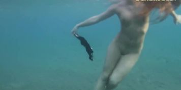 Nude teen girl swims on Tenerife