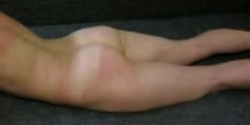 Husband whipping wife in the ground.