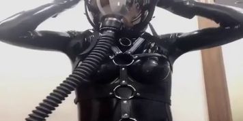 girl in latex wearing gasmask