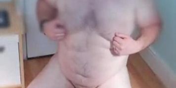 Fat ass shoots cum with long dildo in his ass