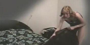 Woman undressing in spied bedroom