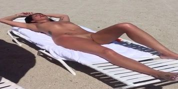 Nude Beach Sleeping MILF with smooth kitty and legs for days.