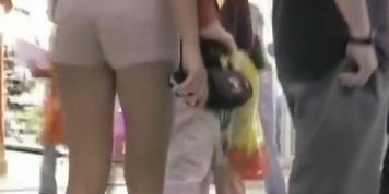 Street candid filmed in the public by a voyeur man