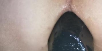 Anal training with a big black dildo