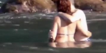 Stones on a naked beach woman