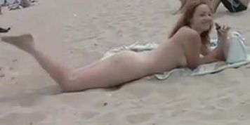 Naughty young nudists play with each other in sand