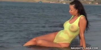 Transparent swimsuit and nude on the beach