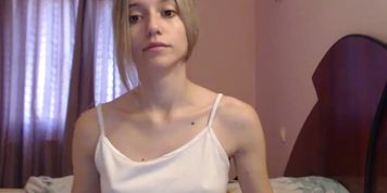 Slim blonde on bed