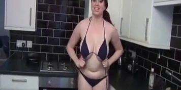 Kiki plays with her boobs in kictchen
