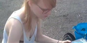 Girl in loose top uncovering her black bra downblouse
