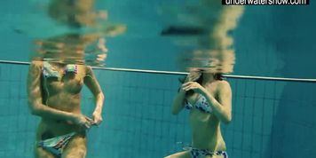 Two sexy amateurs showing their bodies off under water