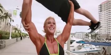 Beautiful Tall muscle woman lift carry overhead her date