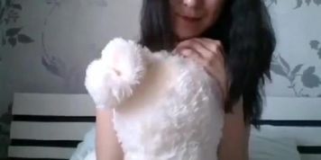 Asian teases on bed