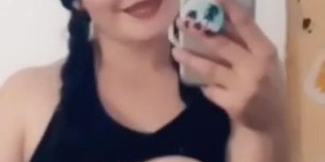 Sexy teen teases with her titties (short clip on a loop)