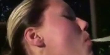 She sucks dick outdoors and eats cum out of a condom