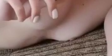Slim white bitch lays naked on sofa and sucks big black dildo 